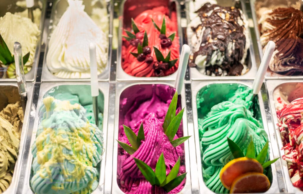 an assortment of gelato flavors in a display case